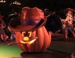 A Farmer Mickey jack o' lantern float, plus one of the Woodys of Disneyland in the background.
