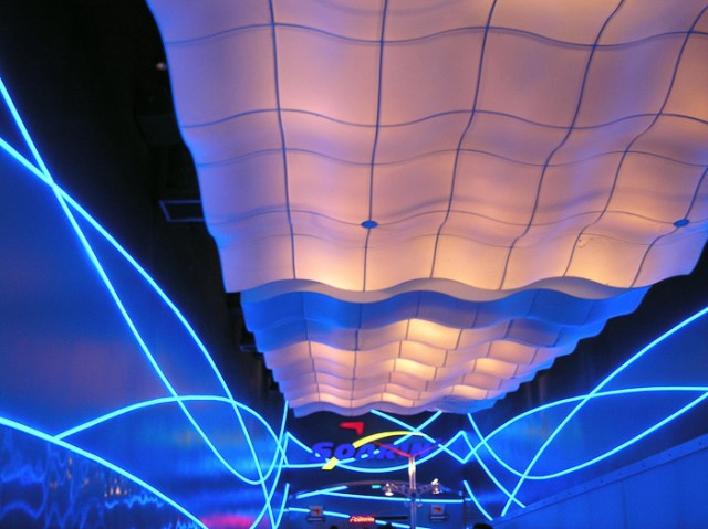 The queue for Soarin' over California celebrates the history of aviation.  The queue for Soarin' celebrates... uh... neon, I guess.